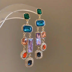 Model showcasing the dangle and style of the 14K Gold-Plated Elegant Colorful Diamond Tassel Earrings