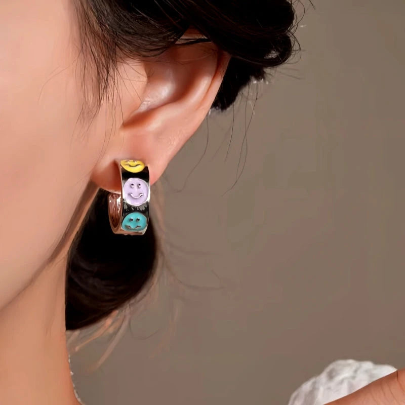 Model showcasing the dangle and style of the 14K Gold-Plated Elegant Colorful Smile Face C-Shaped Earrings
