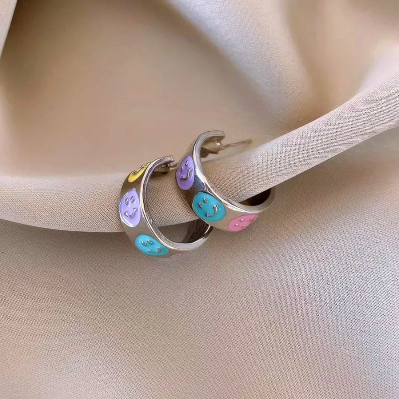 Angled view of the 14K Gold-Plated Elegant Colorful Smile Face C-Shaped Earrings