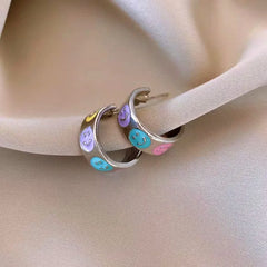 Angled view of the 14K Gold-Plated Elegant Colorful Smile Face C-Shaped Earrings