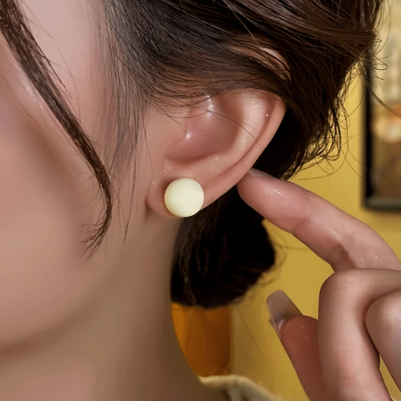 Close-up detail of the sparkling zircons and plating on the Bead Stud Earrings