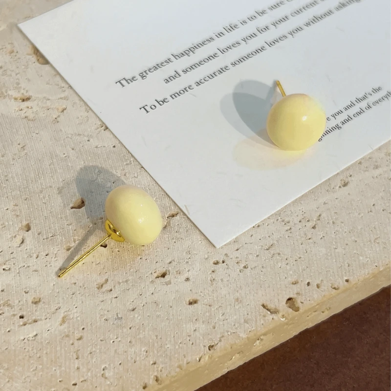 Angled view of the 14K Gold-Plated Elegant Cream White Bead Stud Earrings