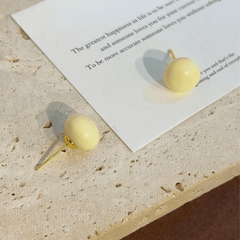 Angled view of the 14K Gold-Plated Elegant Cream White Bead Stud Earrings