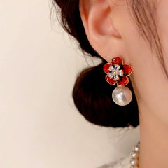 Model showcasing the dangle and style of the 14K Gold-Plated Elegant Crystal Flower Pearl Earrings