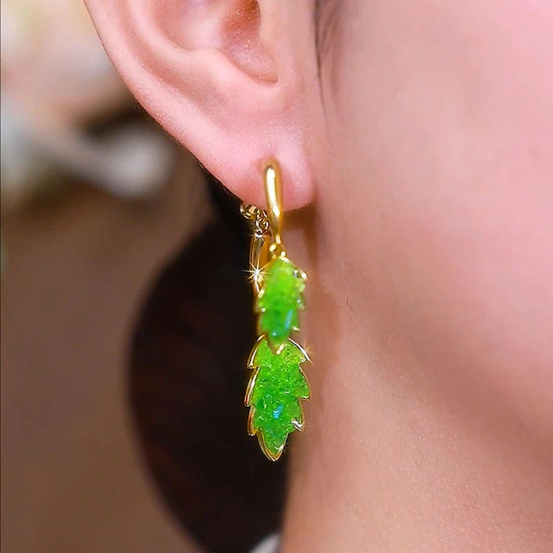 Angled view of the 14K Gold-Plated Elegant Crystal Leaf Cross Earrings