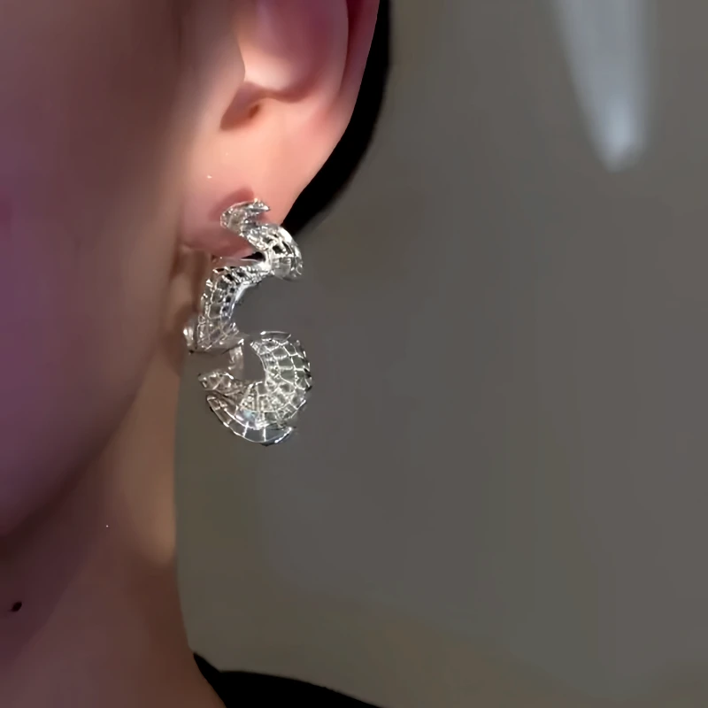 Angled view of the 14K Gold-Plated Elegant Curvy Hollow Lace Hoop Earrings