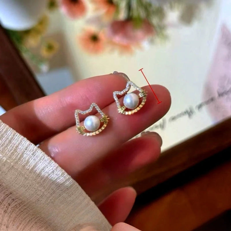 Model showcasing the dangle and style of the 14K Gold-Plated Elegant Cute Cat's Pearl Stud Earrings