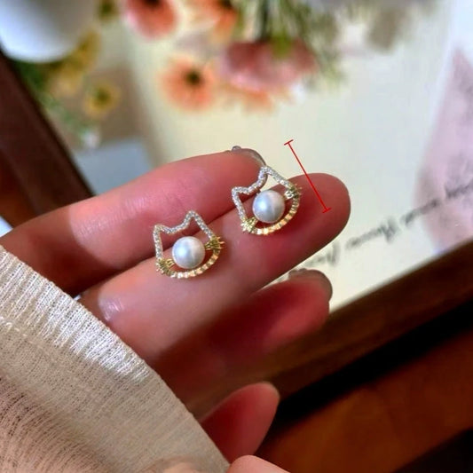 Model showcasing the dangle and style of the 14K Gold-Plated Elegant Cute Cat's Pearl Stud Earrings