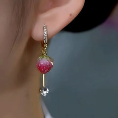 Model showcasing the dangle and style of the 14K Gold-Plated Elegant Cute Pink Strawberry Earrings