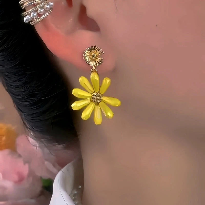 Model showcasing the dangle and style of the 14K Gold-Plated Elegant Daisy Flower Tassel Earrings