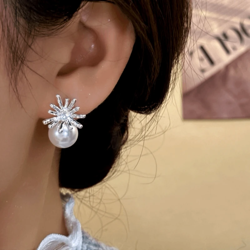 Model showcasing the dangle and style of the 14K Gold-Plated Elegant Daisy Petal Bead Earrings