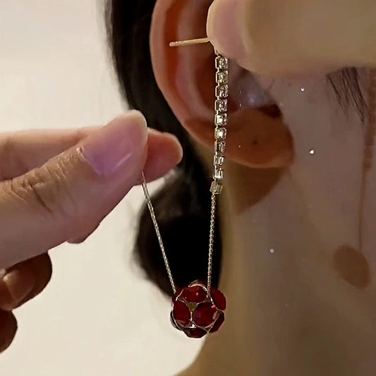 Model showcasing the dangle and style of the 14K Gold-Plated Elegant Diamond Ball Tassel Earrings