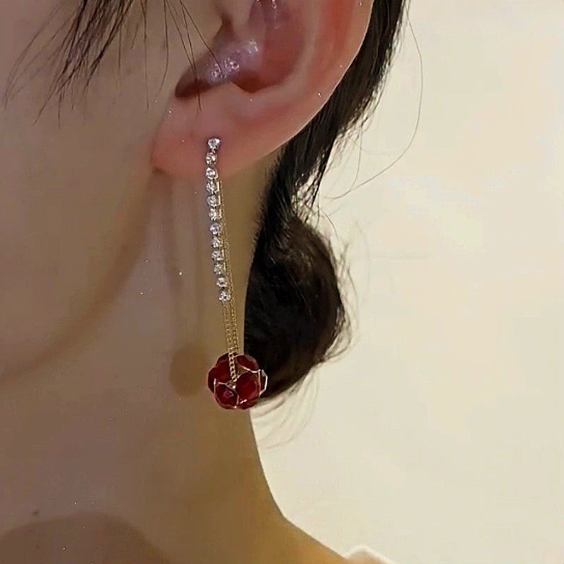 Angled view of the 14K Gold-Plated Elegant Diamond Ball Tassel Earrings