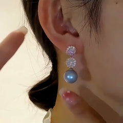 Angled view of the 14K Gold-Plated Elegant Diamond Blue Pearl Earrings