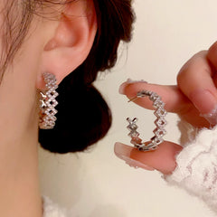 Angled view of the 14K Gold-Plated Elegant Diamond C-Shaped Earrings