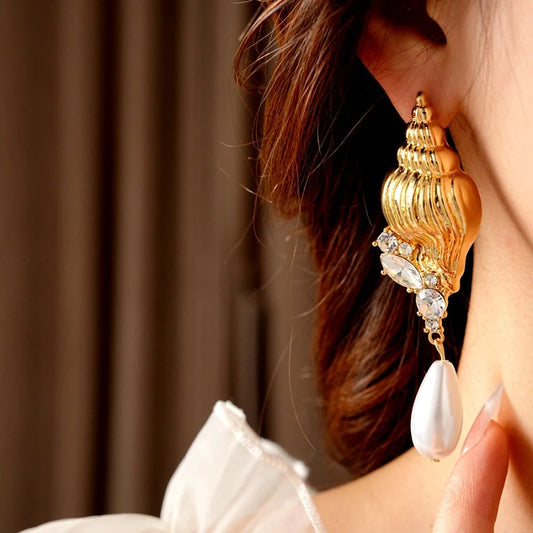 Model showcasing the dangle and style of the 14K Gold-Plated Elegant Diamond Conch Drop Pearl Earrings