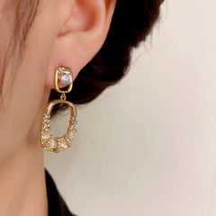 Close-up detail of the sparkling zircons and plating on the Geometric Square Earrings