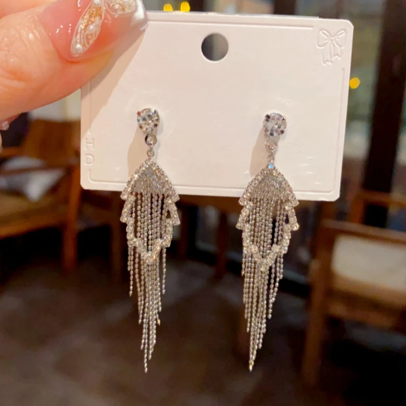 Angled view of the 14K Gold-Plated Elegant Diamond Hollow Leaf Tassel Earrings