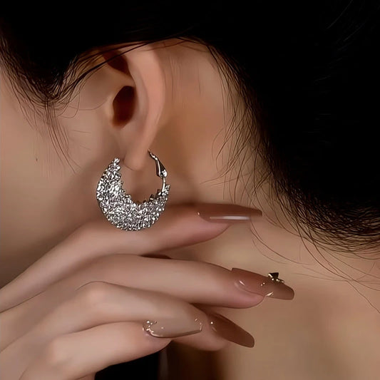 Model showcasing the dangle and style of the 14K Gold-Plated Elegant Diamond Mulberry Stone Bag Earrings