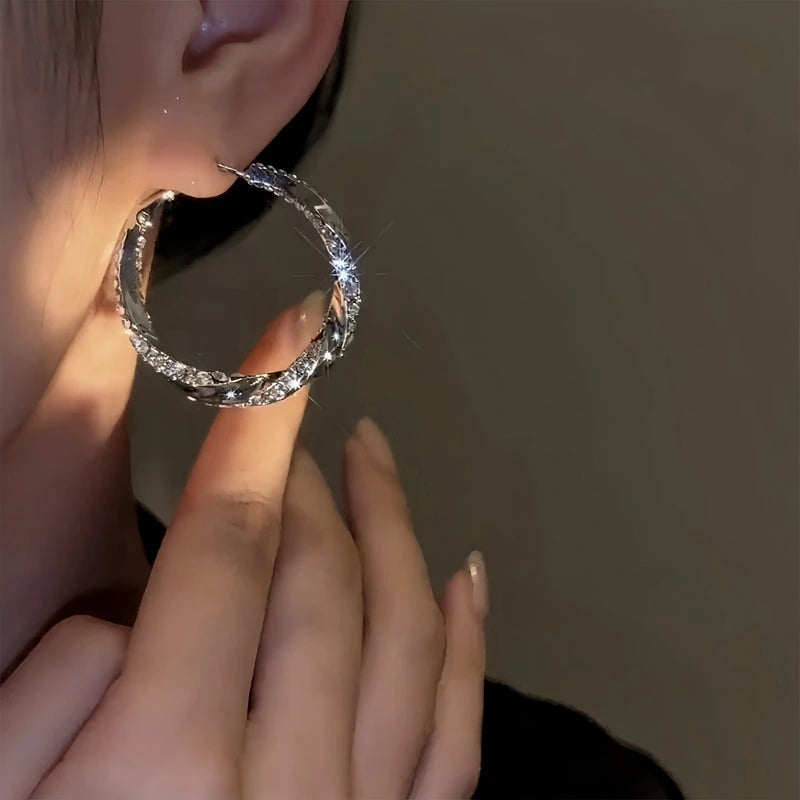 Angled view of the 14K Gold-Plated Elegant Diamond Twisted Hoop Earrings