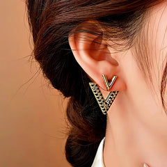 Model showcasing the dangle and style of the 14K Gold-Plated Elegant Diamond V Letter Earrings