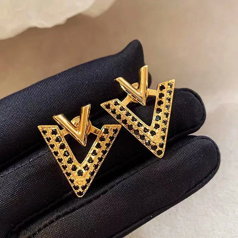 Angled view of the 14K Gold-Plated Elegant Diamond V Letter Earrings