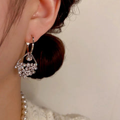 Model showcasing the dangle and style of the 14K Gold-Plated Elegant Diamond Water Drop Earrings