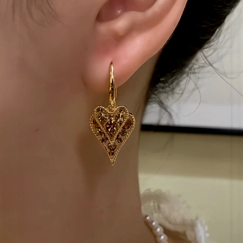 Close-up detail of the sparkling zircons and plating on the Heart Tassel Earrings