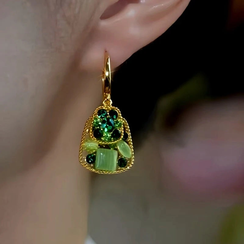 Close-up detail of the sparkling zircons and plating on the Green Statement Earrings