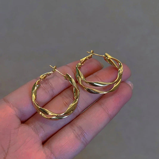 Model showcasing the dangle and style of the 14K Gold-Plated Elegant Double-Layer Hoop Earrings