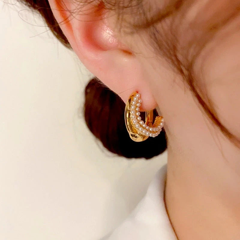 Close-up detail of the sparkling zircons and plating on the Pearl Hoop Earrings