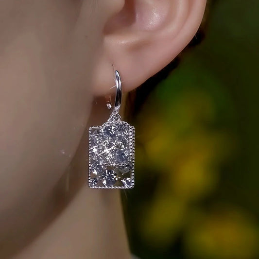 Model showcasing the dangle and style of the 14K Gold-Plated Elegant Double-Layer Zircon Diamond Tassel Earrings