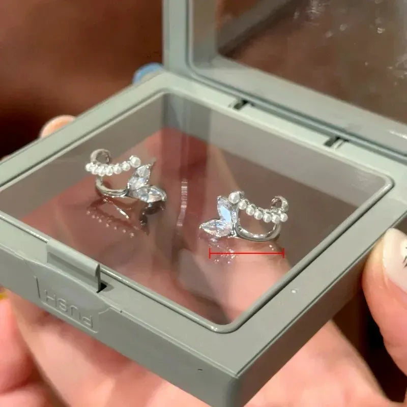 Angled view of the 14K Gold-Plated Elegant Double-Layer Zircon Fishtail Pearl Stud Earrings