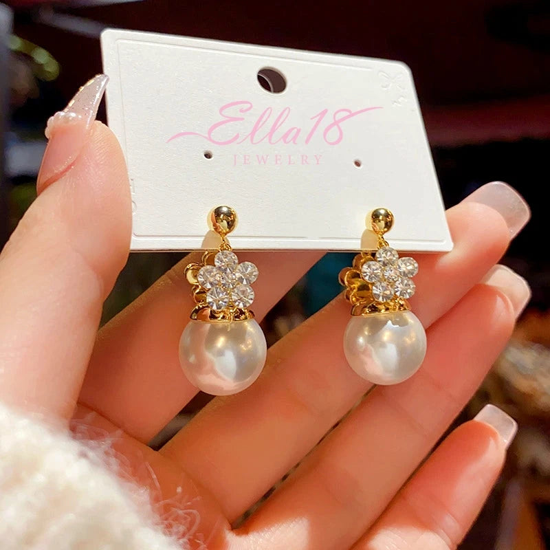 Angled view of the 14K Gold-Plated Elegant Double-Sided Flower Pearl Earrings