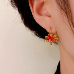 Close-up detail of the sparkling zircons and plating on the Maple Leaf Earrings
