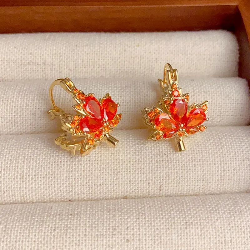 Model showcasing the dangle and style of the 14K Gold-Plated Elegant Double-Sided Maple Leaf Earrings