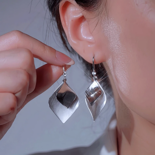 Model showcasing the dangle and style of the 14K Gold-Plated Elegant Double Leaf Ear Hook Earrings