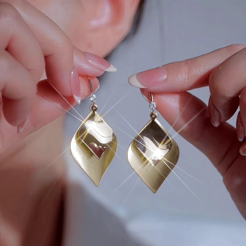 Close-up detail of the sparkling zircons and plating on the Leaf Ear Hooks