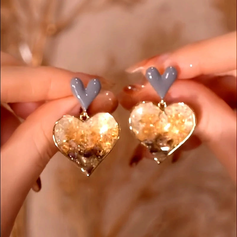 Model showcasing the dangle and style of the 14K Gold-Plated Elegant Double Love Gradient Crystal Earrings