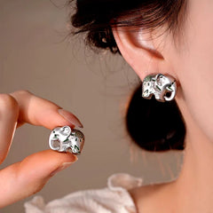 Model showcasing the dangle and style of the 14K Gold-Plated Elegant Elephant Stud Earrings