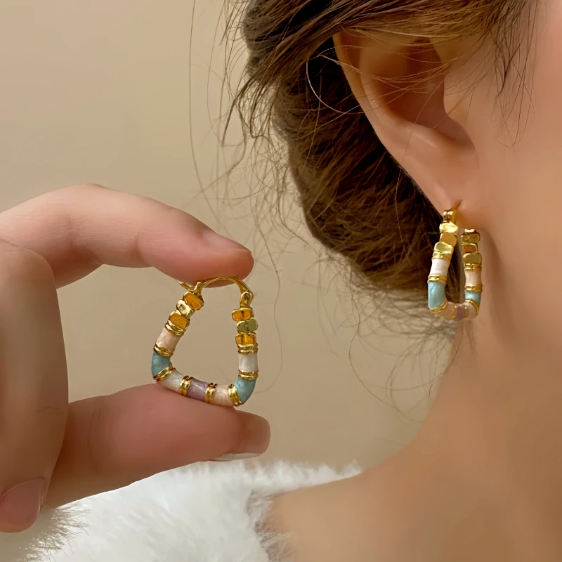 Model showcasing the dangle and style of the 14K Gold-Plated Elegant Enamel Dripping Geometric Earrings