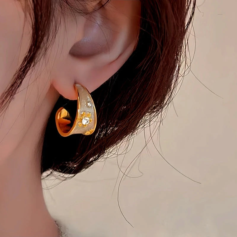 Model showcasing the dangle and style of the 14K Gold-Plated Elegant Enamel Flower Earrings