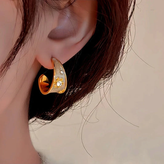 Model showcasing the dangle and style of the 14K Gold-Plated Elegant Enamel Flower Earrings