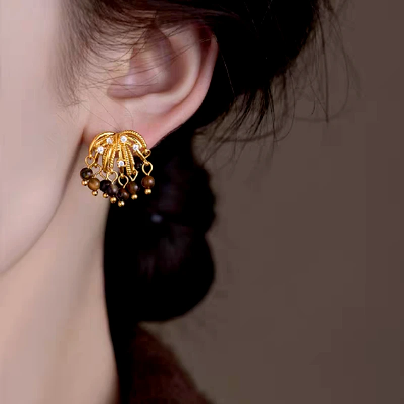 Close-up detail of the sparkling zircons and plating on the Firework Tassel Earrings