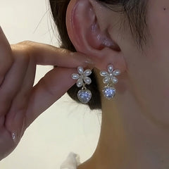 Close-up detail of the sparkling zircons and plating on the Crystal Heart Earrings