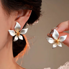 Model showcasing the dangle and style of the 14K Gold-Plated Elegant Flower Earrings