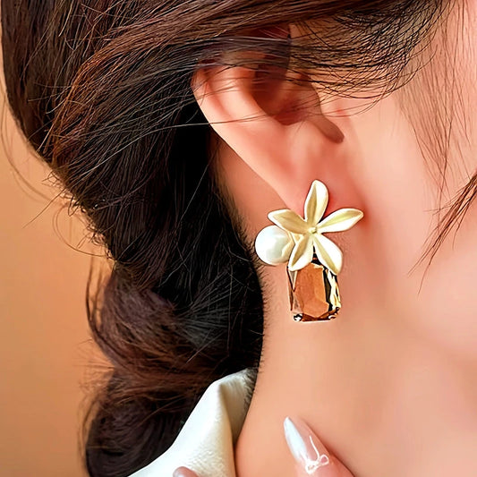 Model showcasing the dangle and style of the 14K Gold-Plated Elegant Flower Pearl Crystal Earrings