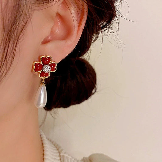 Model showcasing the dangle and style of the 14K Gold-Plated Elegant Flower Pearl Earrings