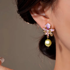 Model showcasing the dangle and style of the 14K Gold-Plated Elegant Flower Pearl Tassel Earrings