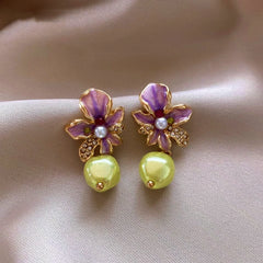 Angled view of the 14K Gold-Plated Elegant Flower Pearl Tassel Earrings